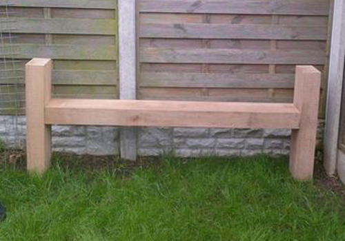 A high sided seat from benches made from sleepers and cleanly sanded back